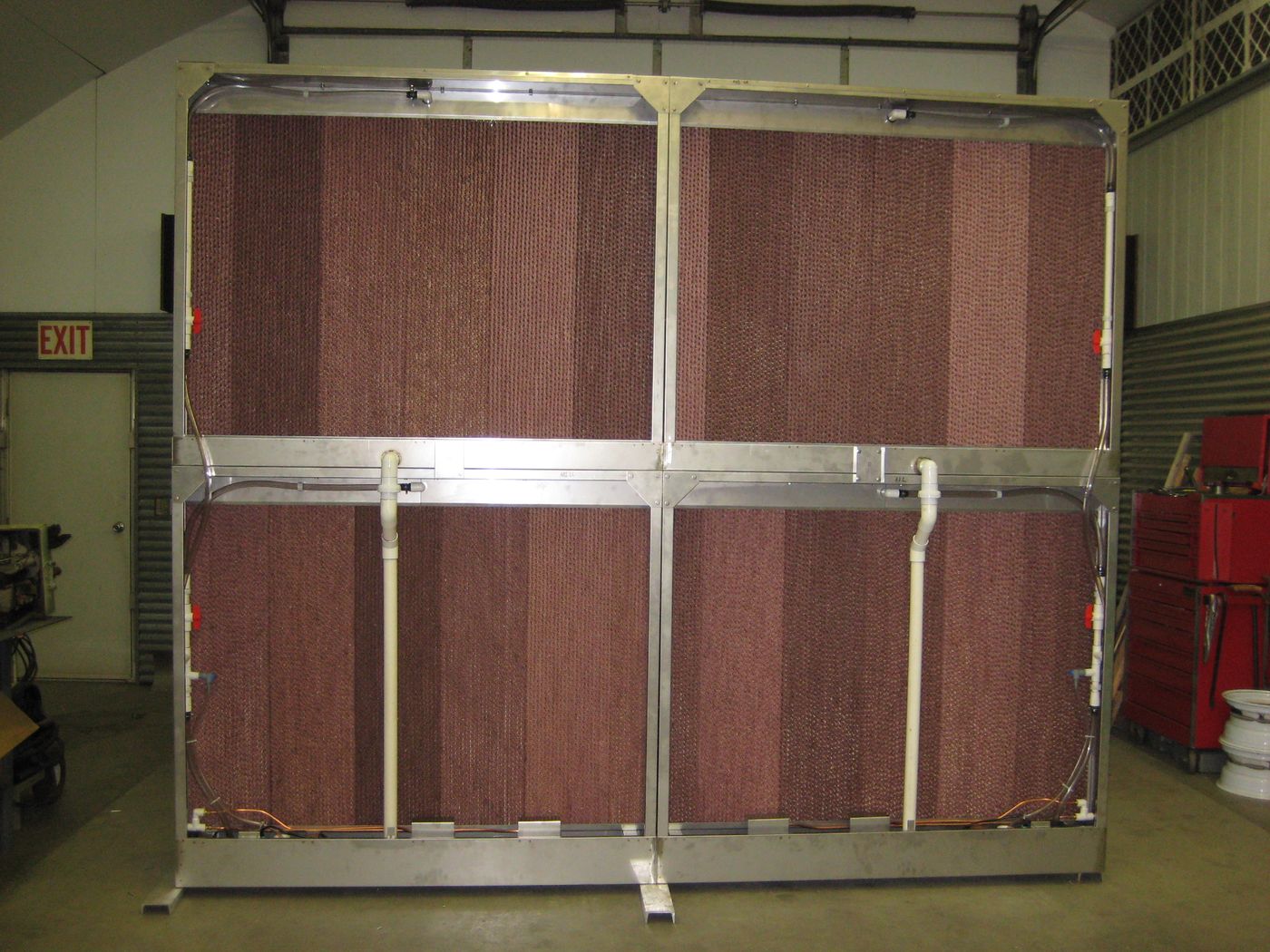 Stainless steel evaporative wet section with four banks of rigid media, built to install inside an air handler